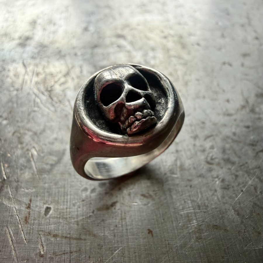 Sterling silver, hand carved signet ring with a skull.