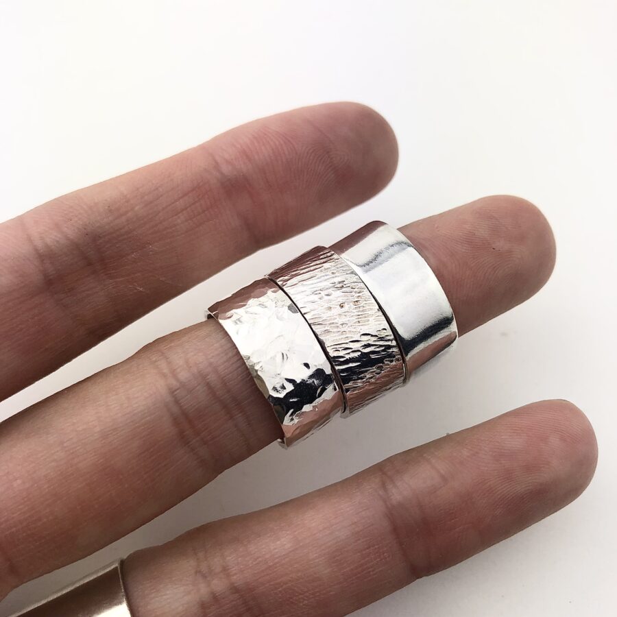 Wide band sterling silver ring with a smooth, polished finish and clean, minimalist design.