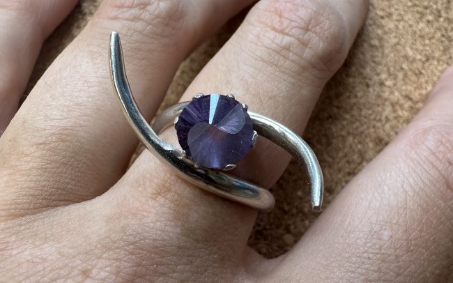 Sterling silver ring with an alexandrite set in a crown, with a yin & yang design on the face