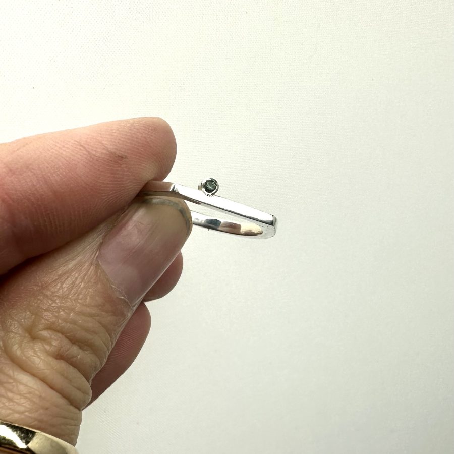 Horseshoe shaped sterling silver ring with on offset tourmaline.
