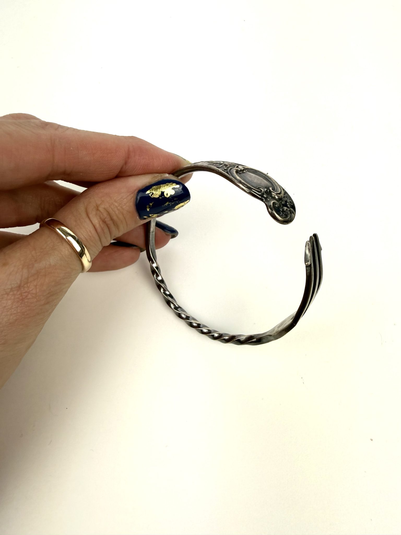 An open cuff made from a vintage pickle fork