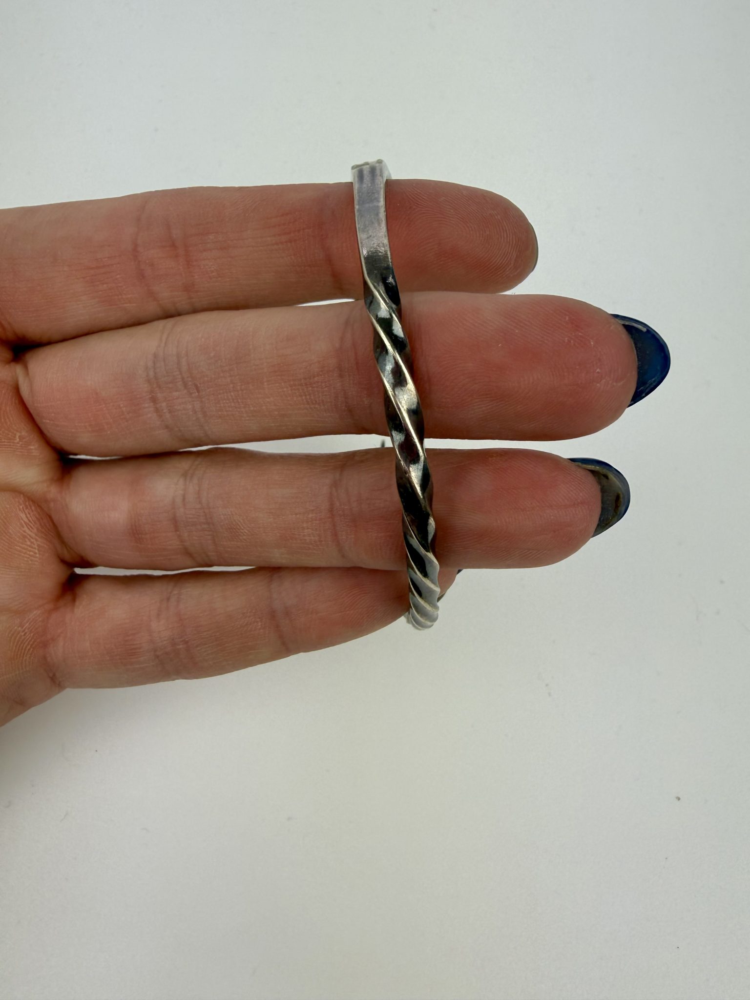 An open cuff made from a vintage pickle fork