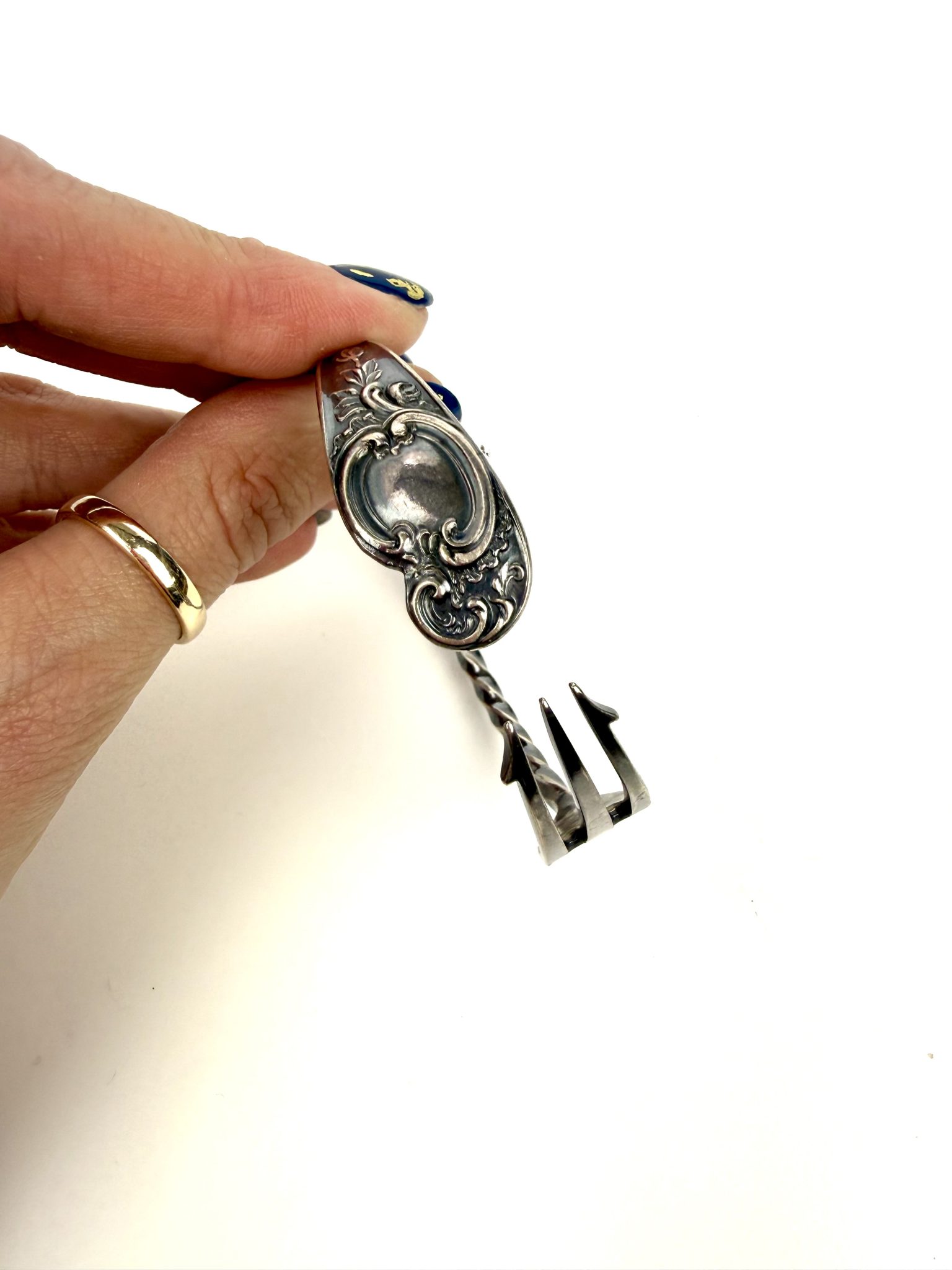An open cuff made from a vintage pickle fork