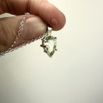 A beautiful Brazillian green amethyst teardrop wet in sterling silver with one gold claw