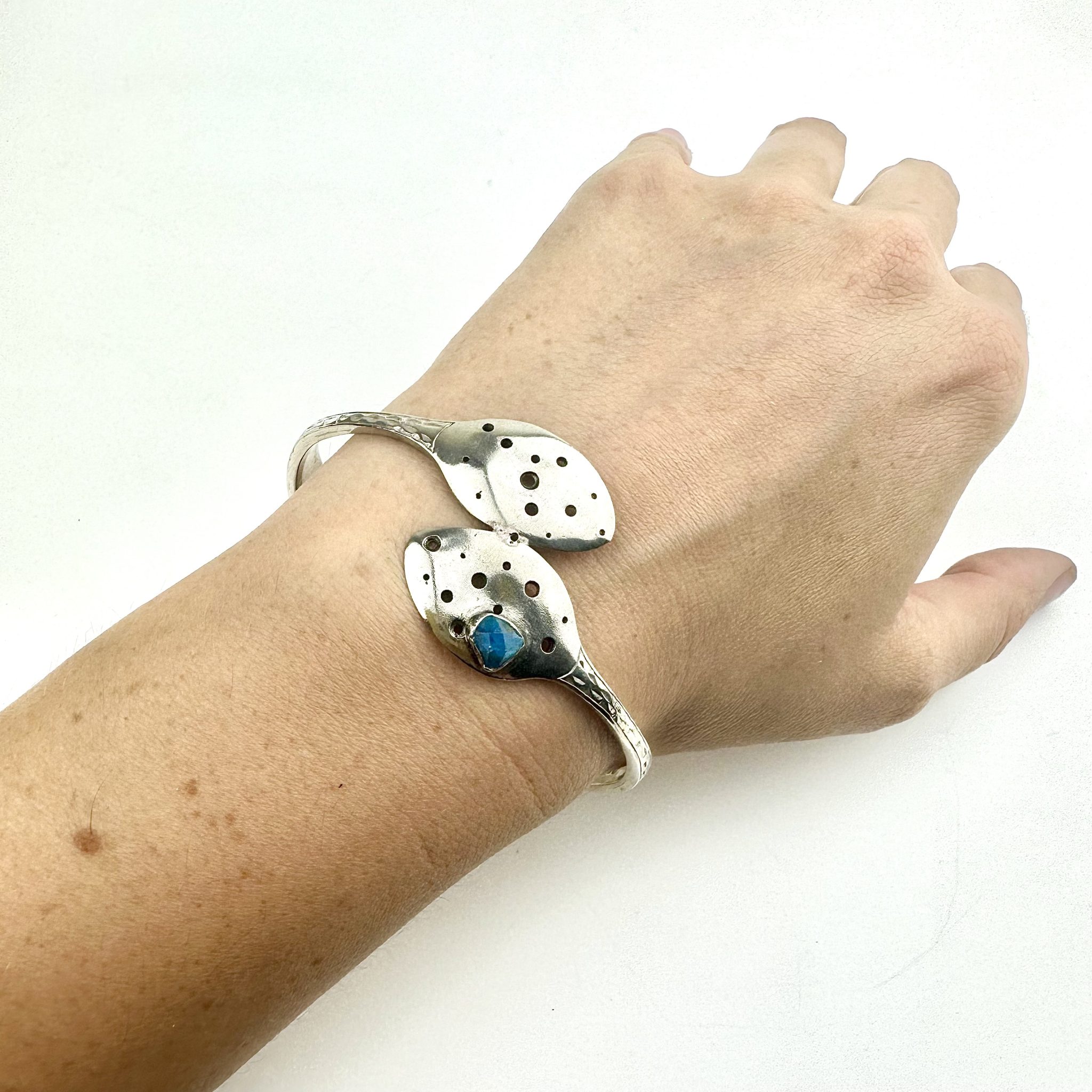 A vintage pair of silver pate sugar tongs, carefully formed to make a bangle and set with a an apatite stone