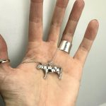 A sterling silver cow pendant.
