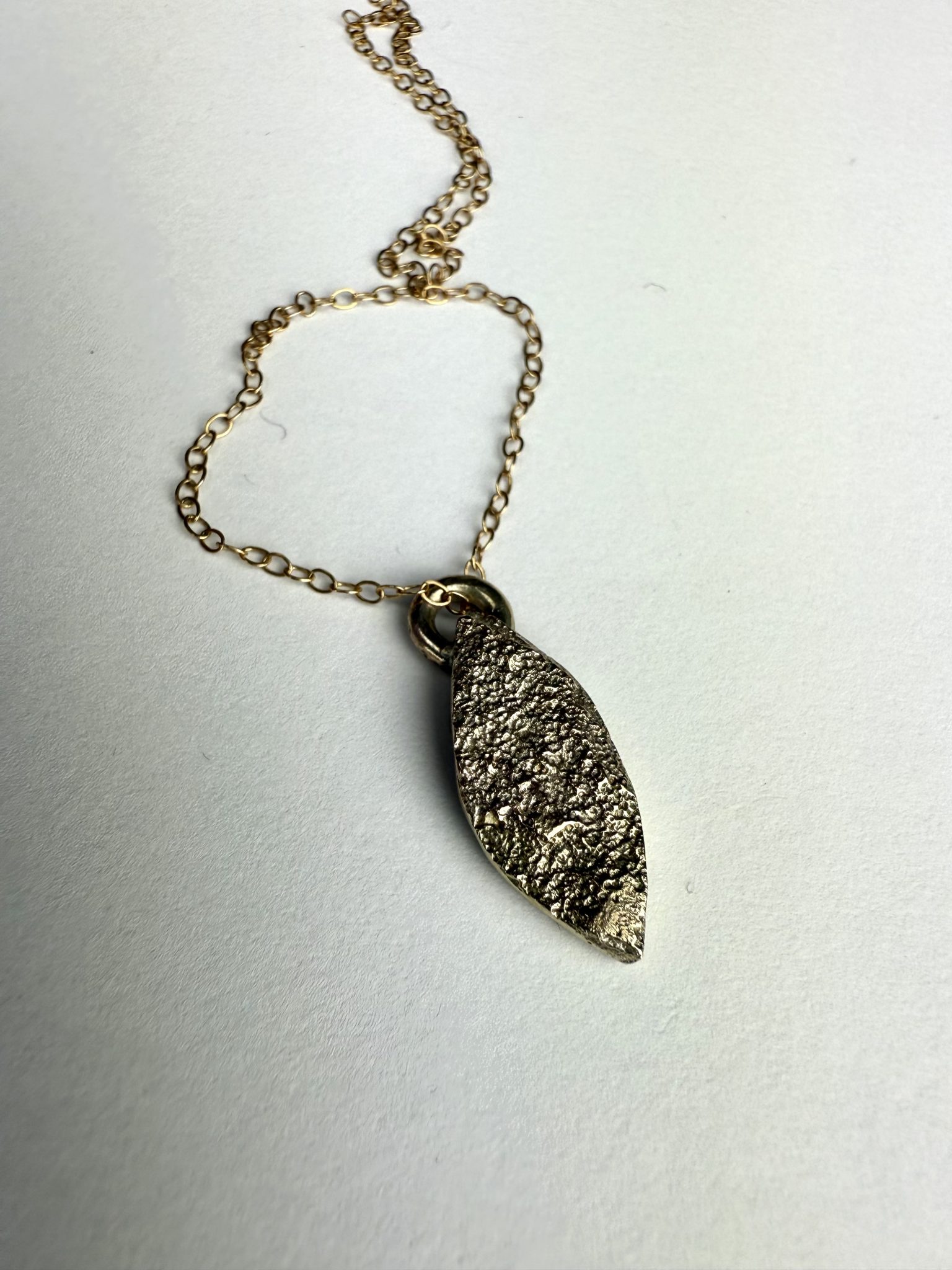 9ct gold sand cast marquise shaped pendant.