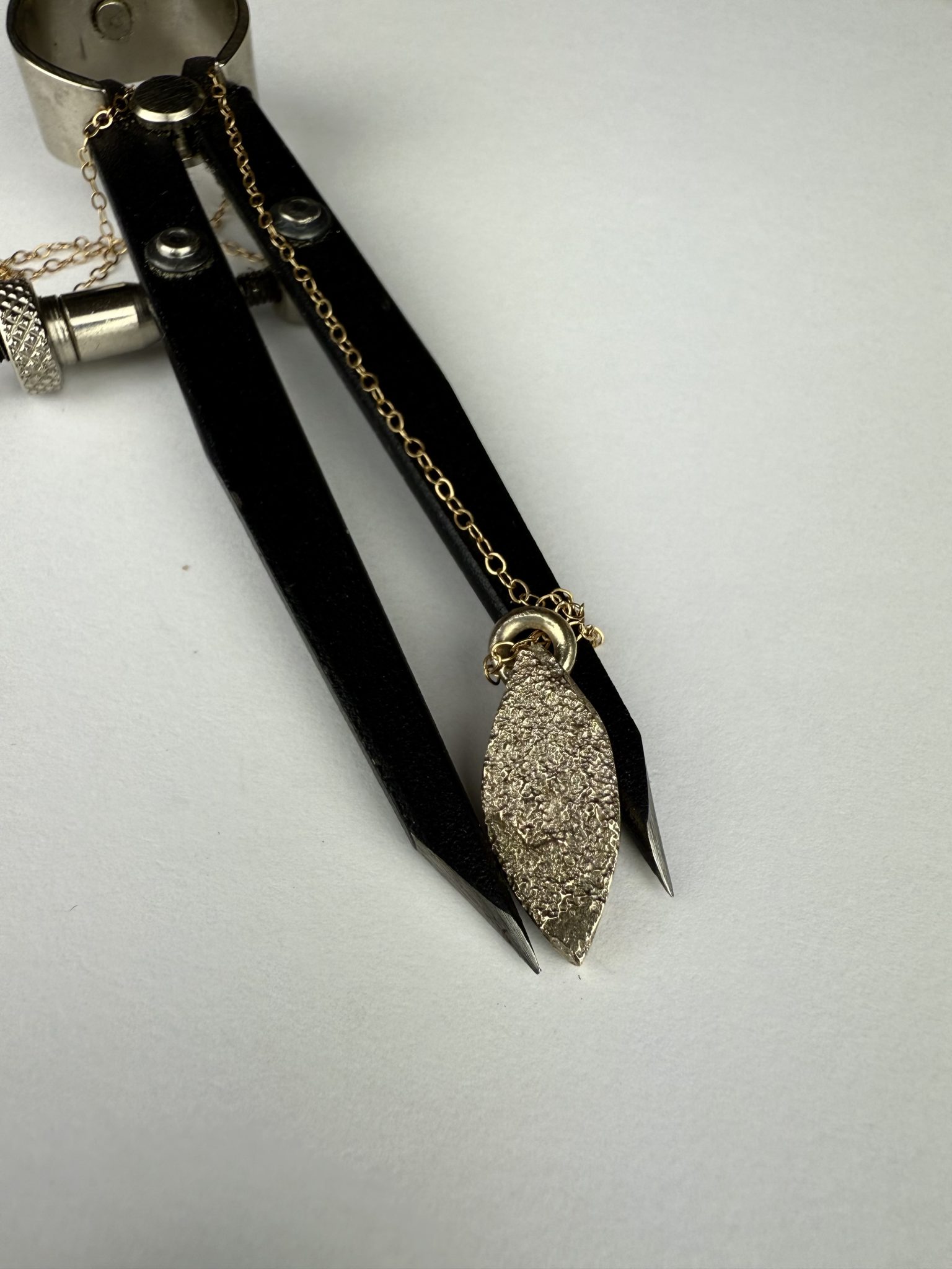 9ct gold sand cast marquise shaped pendant.