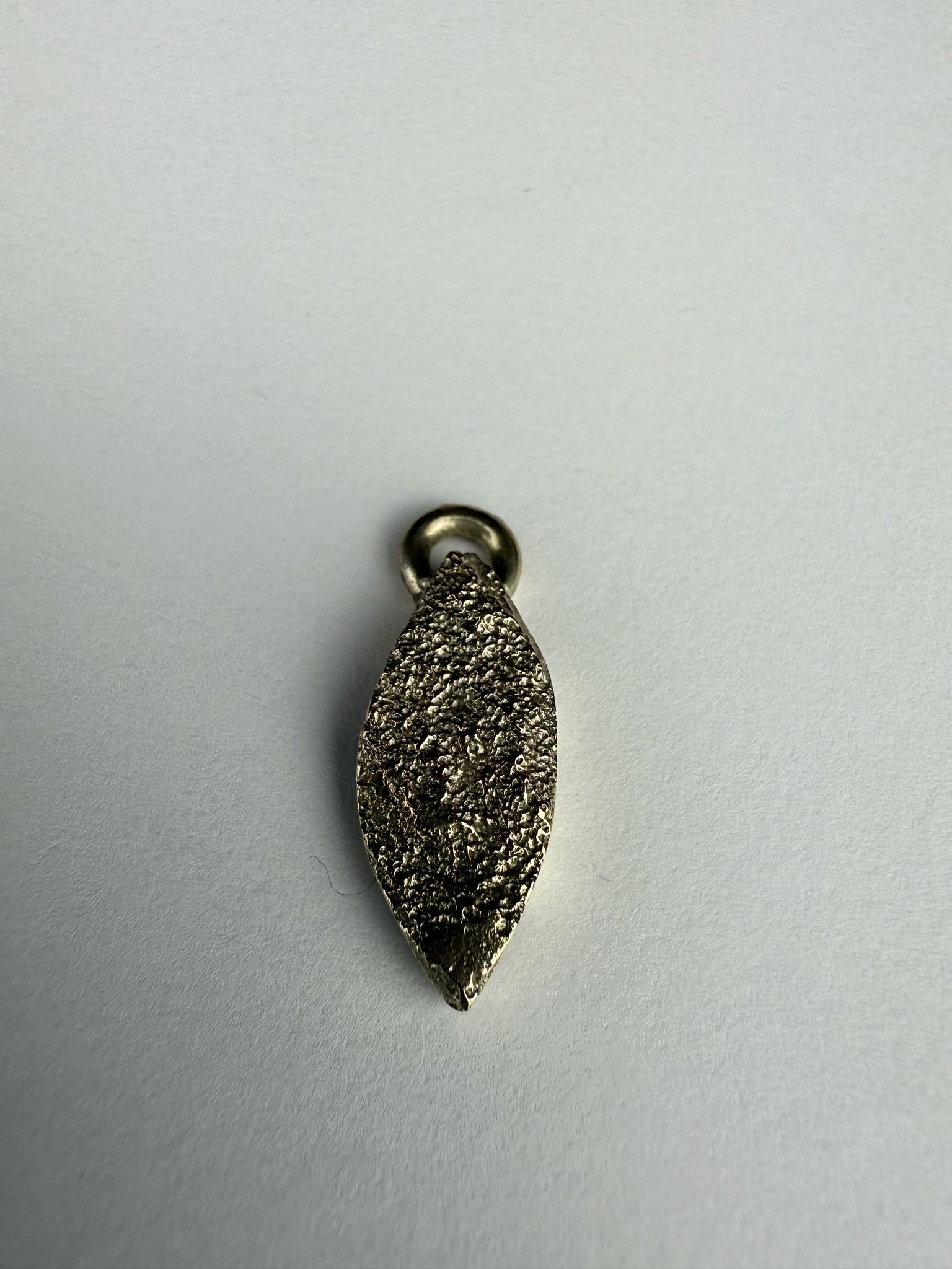 9ct gold sand cast marquise shaped pendant.