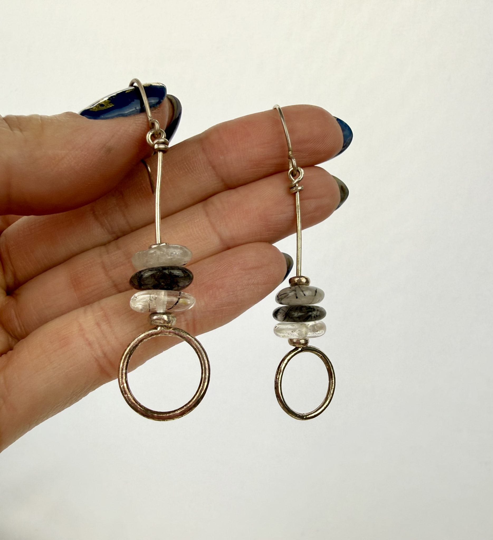 Sterling silver and rutliated quartz long drop earrings, featuring three bead and a loop at the bottom.