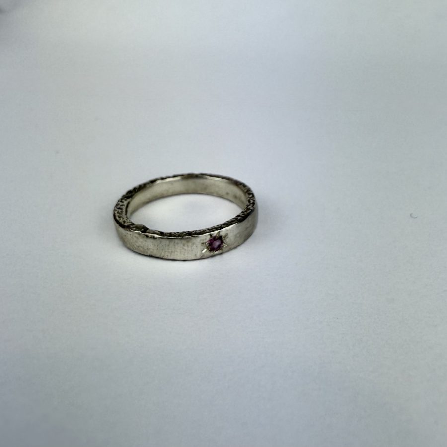 sterling silver ring, sand cast and featuring a rhodalite garnet grain set in the band.