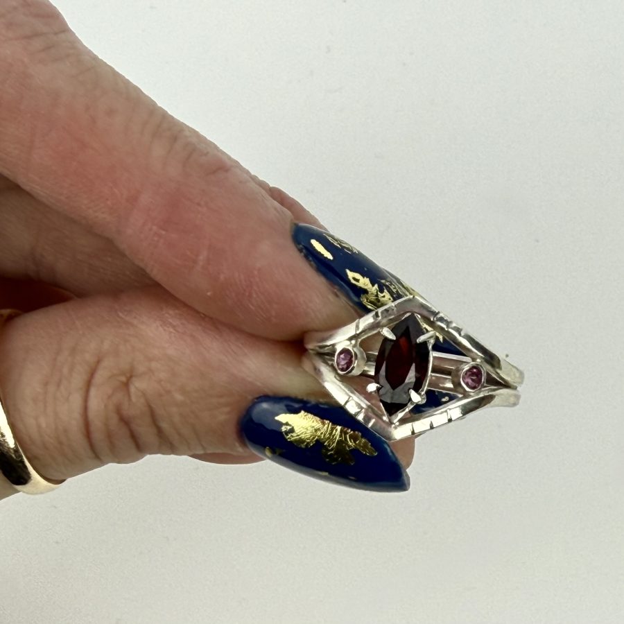 Sterling silver marquise garnet ring with rhodalite garnet accent stones and an open geometric design, bold, and perfect for a modern statement look.